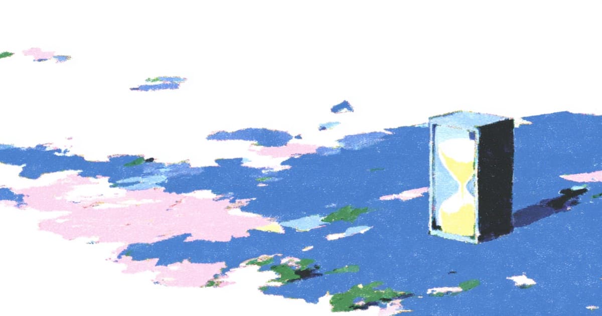 Hourglass standing on a flat surface under a cloudy sky